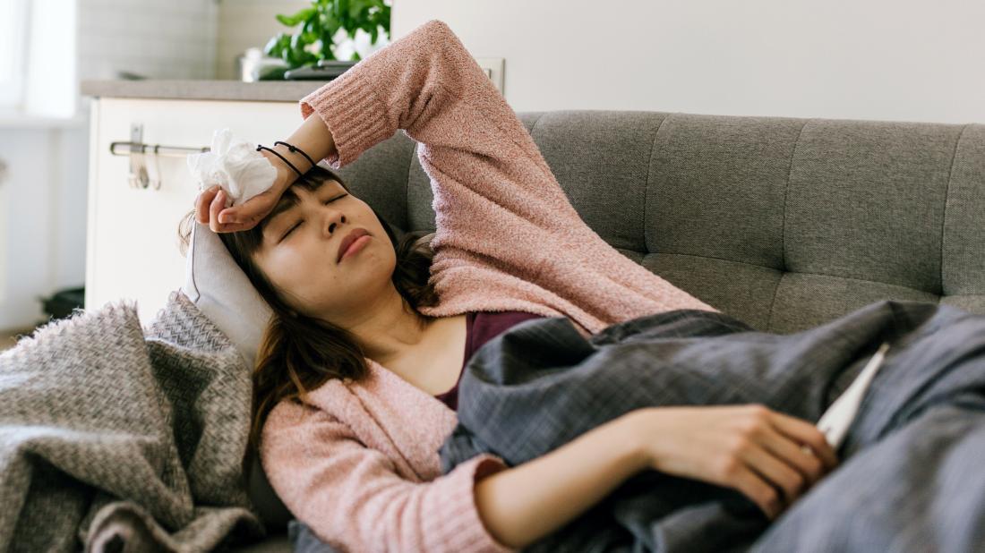 a person lying on the sofa with a fever because of meningococcal disease