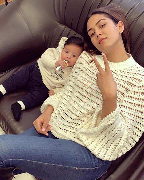 There's no reason moms can't twin with their baby boys. Mira is seen wearing a white top with Zain sporting a sweatshirt of the same color.